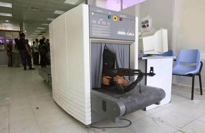 Hamasl bir militan 
Msr'la Gazze eridi snrndaki Rafah k kapsnda yakalanacan anlayan Hamasl bir militan X-Ray cihaznn iine uzandktan sonra silahyla nian alrken
